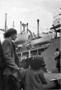 Sophie and son Hank (Vytautas) Endzelis, displaced persons from Lithuania, prepare to board their ship to the U.S. in Tubingen, Germany in 1948