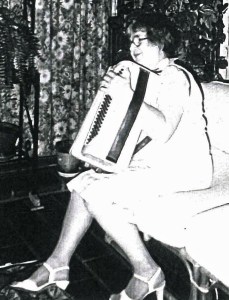 Josephine (Kohlrus) Baksys playing son-in-law Jay Wheeler's accordion, 1984, Courtland, Calif.