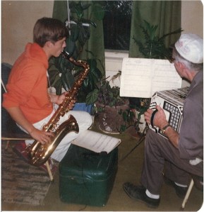 Young David Black plays tenor sax with his grandpa, John Galman, Jr., on concertina, 1979.