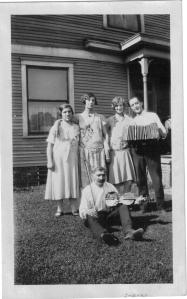 Anna (Klimaitis) Bernotas with her mother, Anna (left) and her sister Adella (right).  Sitting man with fiddle possibly young Anna's husband Peter Bernotas.  Circa 1925.